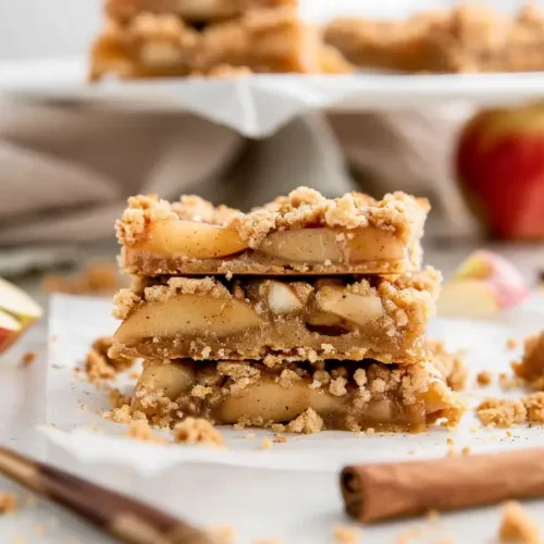 Gluten-Free Apple Pie Bars stacked with golden shortbread and warm spiced apple filling.