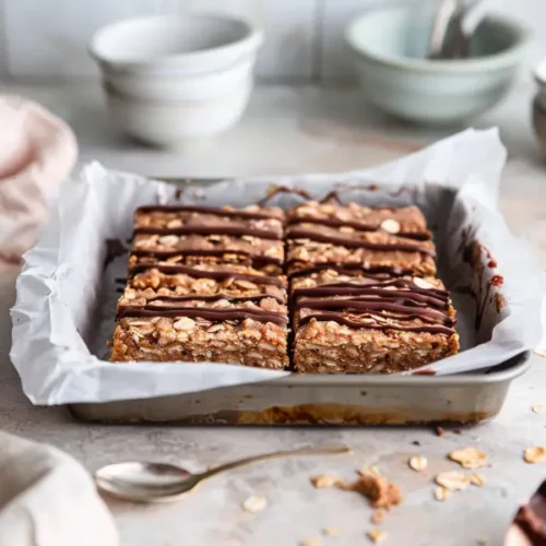 No-Bake SunButter Oat Bars cut into clean, square pieces with a soft chocolate drizzle.