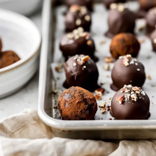The Best Gluten Free Sugar Free Desserts for a Healthy Sweet Tooth 23 Gingerbread Truffles (No Bake, Sugar-Free) arranged closely with soft warm light and smooth chocolate coating.