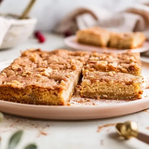 The Best Easy Gluten Free Thanksgiving Desserts for a Crowd 13 Close-up of sliced Gluten-Free Snickerdoodle Bars with a golden cinnamon-sugar top.