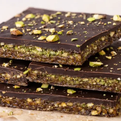 Dubai chocolate date bark squares beside handwritten recipe card